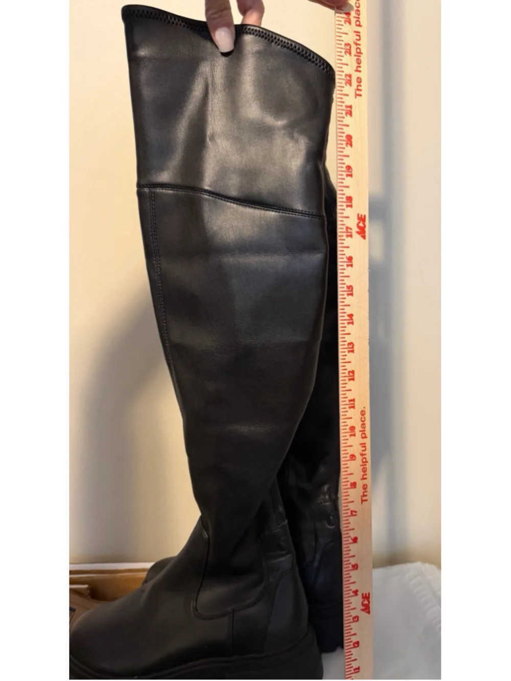 Calvin Klein black chunky platform boots featuring a thick, ridged lug sole.